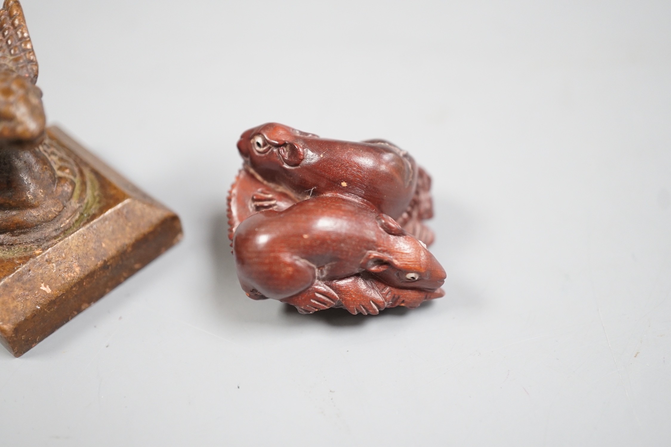 A Chinese bronze 'cobra' seal and a Japanese carved wood netsuke with signed mother of pearl tablet to underside. Seal 4cm tall